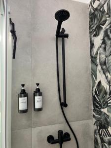 a shower with two bottles of soap in a bathroom at Tropical house in Lecce +19 photos