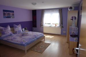 a bedroom with a bed and a window at Ferienwohnung Grebner in Schalkau