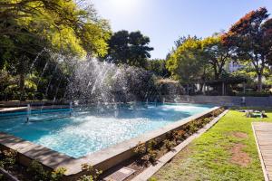 a swimming pool with a fountain in a park at Home2Book Stylish Sea Views Studio Santa Cruz in Santa Cruz de Tenerife