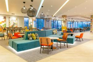 布莱克本Hampton By Hilton Blackburn的餐厅配有色彩缤纷的家具和桌椅