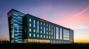 a building with a sign on the side of it at Hampton By Hilton Blackburn in Blackburn