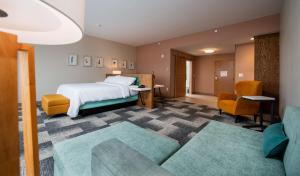 a hotel room with a bed and a couch at Hilton Garden Inn Moncton Downtown, Nb in Moncton +44 photos