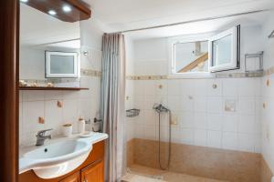 a bathroom with a sink and a shower at Anna House in Panteli