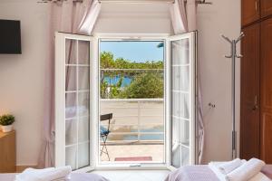 a bedroom with a door open to a balcony at Anna House in Panteli