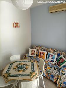 a living room with a table and a couch at Residenza estiva al Borgo Rio Favara in Santa Maria del Focallo