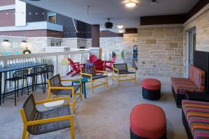 a restaurant with colorful chairs and tables on a patio at Home2 Suites by Hilton Fort Worth Cultural District in Fort Worth