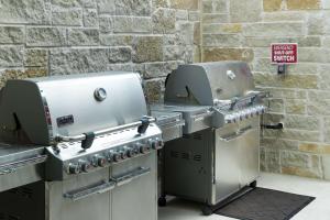 two grilling machines sitting next to a brick wall at Home2 Suites by Hilton Fort Worth Cultural District in Fort Worth
