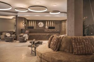 a lobby with a couch and a reception desk at Hotel Post in Kaltenbach