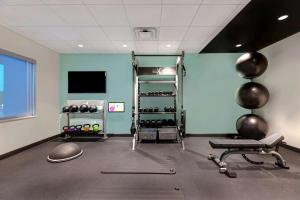 a fitness room with a gym with a bench and weights at Tru By Hilton Grantville, Pa in Grantville