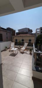 a patio with chairs and tables on a roof at Casa Glicine in Milazzo