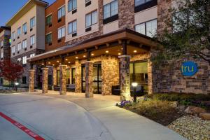 a hotel building with a sign on the front of it at Tru By Hilton Rockwall Dallas, Tx in Rockwall