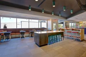 a restaurant with a bar and some stools at Tru By Hilton Monroe, Oh in Monroe