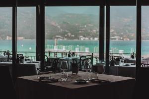 a table in a restaurant with a view of the ocean at Bella Hotel & Restaurant with private dock for mooring boats in San Felice del Benaco +37 photos