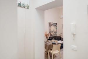 a dining room and living room with a table and chairs at La casetta del SI minore in Bari +27 photos