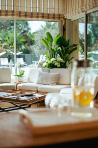 a living room with a couch and a table at Boutique Hôtel Villa Fabulite in Antibes