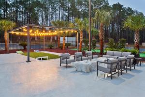 a patio with a table and chairs and lights at Doubletree By Hilton Dothan, Al in Dothan