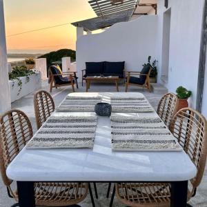 a white table with chairs on a patio at Pytilia in Agiassos