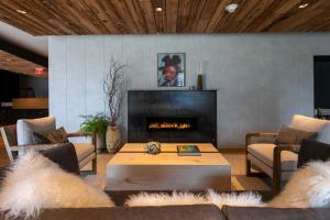 a living room with a couch and a fireplace at The Lloyd Stamford, Tapestry Collection by Hilton in Stamford