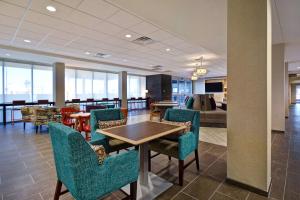 a dining room with a table and chairs and a living room at Home2 Suites By Hilton Odessa in Odessa
