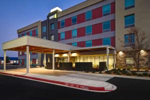 a hotel building with a parking lot in front of it at Home2 Suites By Hilton Odessa in Odessa