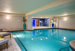 a large swimming pool in a hotel room at Leonardo Royal Hotel Brighton Waterfront in Brighton & Hove