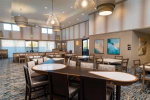 a dining room with tables and chairs and windows at Homewood Suites By Hilton Livermore, Ca in Livermore