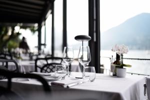 a table with wine glasses sitting on top of it at Bella Hotel & Restaurant with private dock for mooring boats in San Felice del Benaco