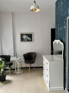 a room with a white dresser and a table and chairs at Gaia Art Hostel Hotel in Istanbul