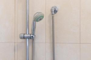 a shower with a shower head and a hose at Villa Maria in Castellaneta +25 photos