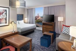 a hotel room with a bed and a television at Homewood Suites by Hilton Boston Seaport District in Boston