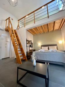 a bedroom with a bed and a stair case at Privileged villa in Néa Péramos