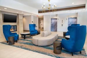 a lobby with a couch and chairs and a tv at Homewood Suites by Hilton Baltimore - Arundel Mills in Hanover