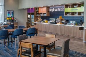 a restaurant with tables and chairs and a counter at Home2 Suites By Hilton Boise Downtown in Boise