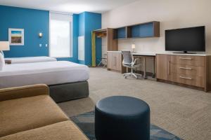 a hotel room with two beds and a flat screen tv at Home2 Suites By Hilton Boise Downtown in Boise