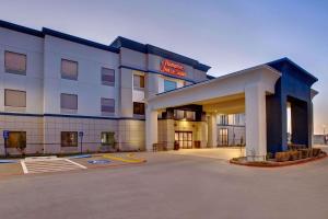 a hotel with a parking lot in front of it at Hampton Inn & Suites Borger in Borger
