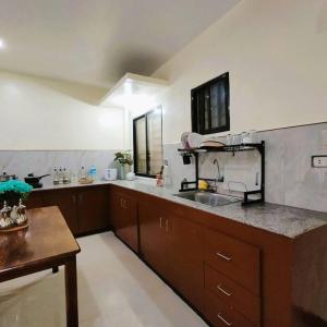 a kitchen with a sink and a counter top at Stellar Homesharing 1 in Davao City
