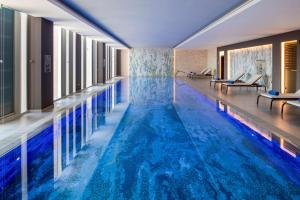 a swimming pool with blue water in a hotel room at DoubleTree Suites by Hilton - Riyadh Financial District in Riyadh