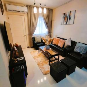 ein Wohnzimmer mit einem Sofa und einem Tisch in der Unterkunft Stellar Homesharing 1 in Davao City