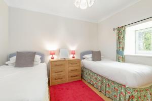two twin beds in a room with a window at Barn Cottage 2 bedroom with gorgeous views in Dunblane