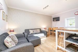 a living room with a couch and a table at Barn Cottage 2 bedroom with gorgeous views in Dunblane