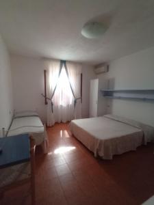 Postel nebo postele na pokoji v ubytování B&B da AnnaMaria