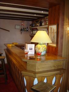 a bar with a lamp on top of it at Hôtel Belalp in Châtel