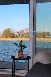 a bedroom with a view of a body of water at Hausboot Wangermeer Nordsonne11 in Wangerland