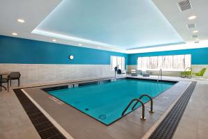 a large pool in a room with blue walls at Hampton Inn & Suites Ottawa West, Ontario, Canada in Ottawa