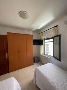 a bedroom with a bed and a large window at apartament la cova in Peralada
