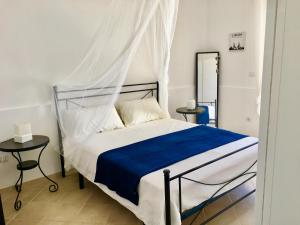 a bedroom with a bed with a canopy at Villa Sole Maldive del Salento in Torre Pali