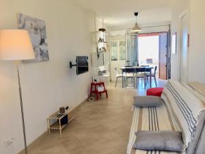a living room with a bed and a dining room at Villa Sole Maldive del Salento in Torre Pali