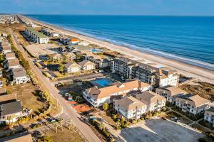 an aerial view of a beach with condos and the ocean at Beach Bliss in Ocean Isle Beach