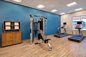 a gym with two treadmills and two exercise bikes at Hampton Inn Brockville, On in Brockville
