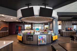 a fast food restaurant with a counter with food at Tru By Hilton Phoenix Glendale Westgate in Glendale